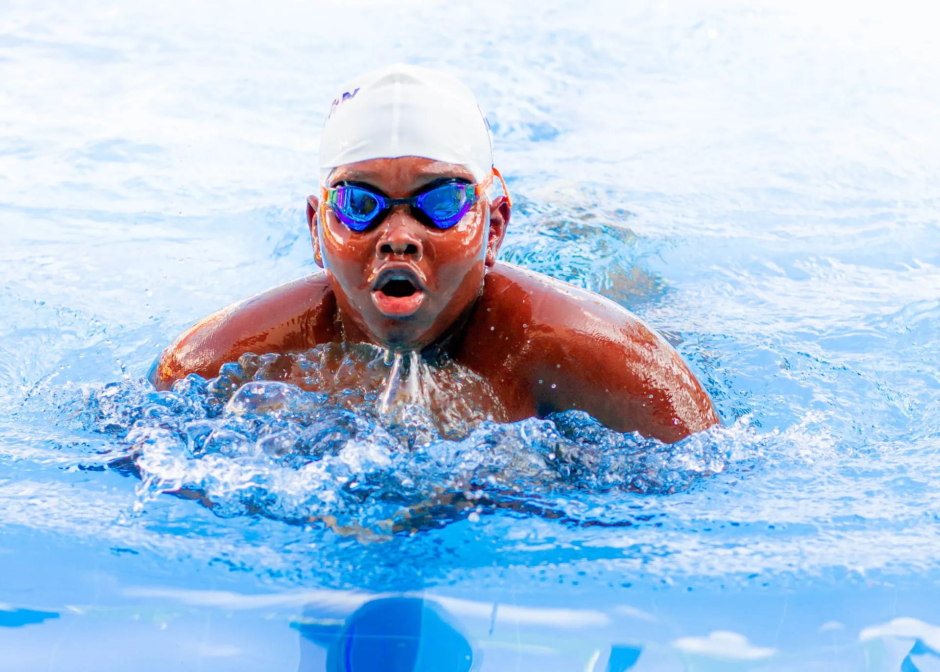 A determined breaststroker powering through the water.