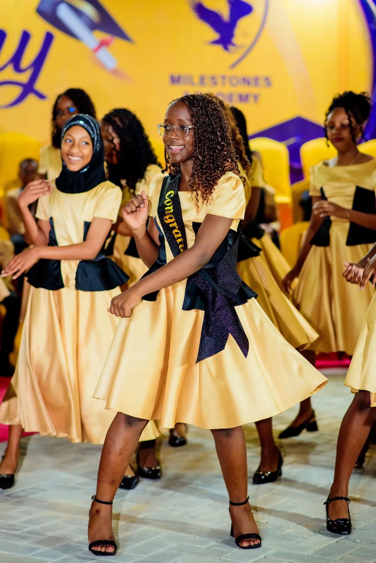 Graduates celebrating with a joyful dance.