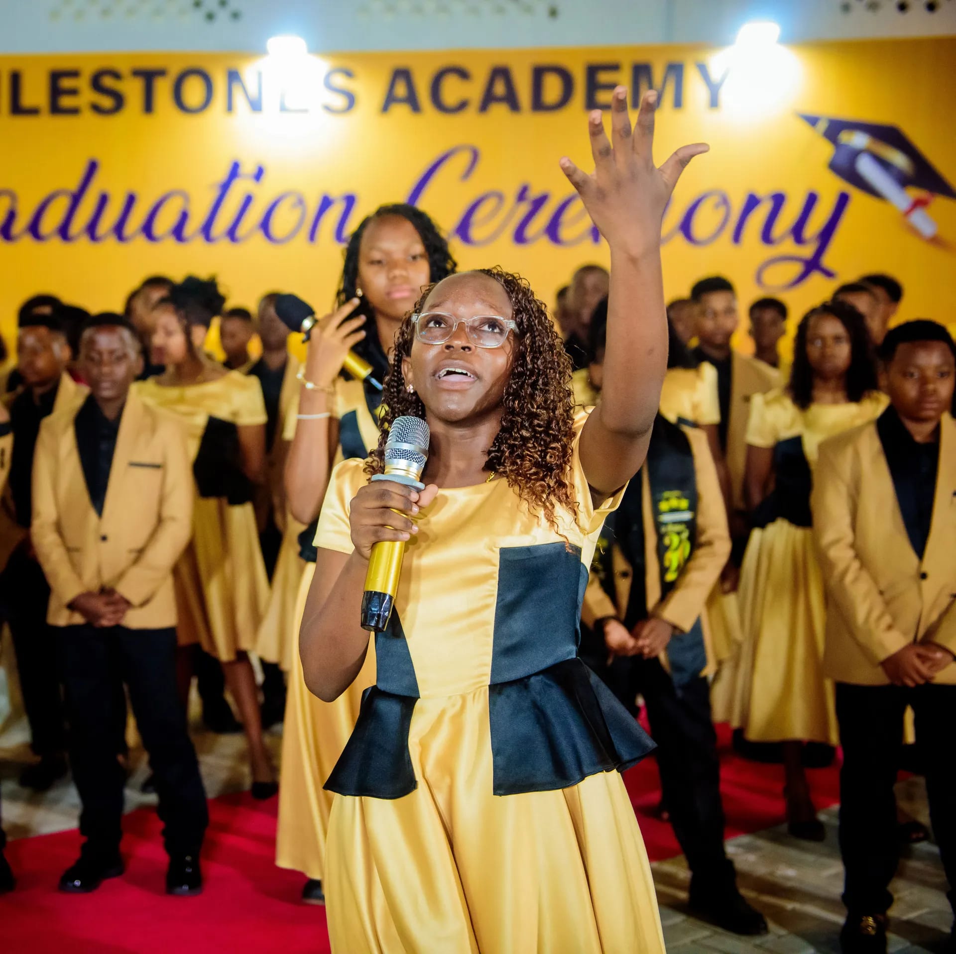 A graduate leading the celebration in song.