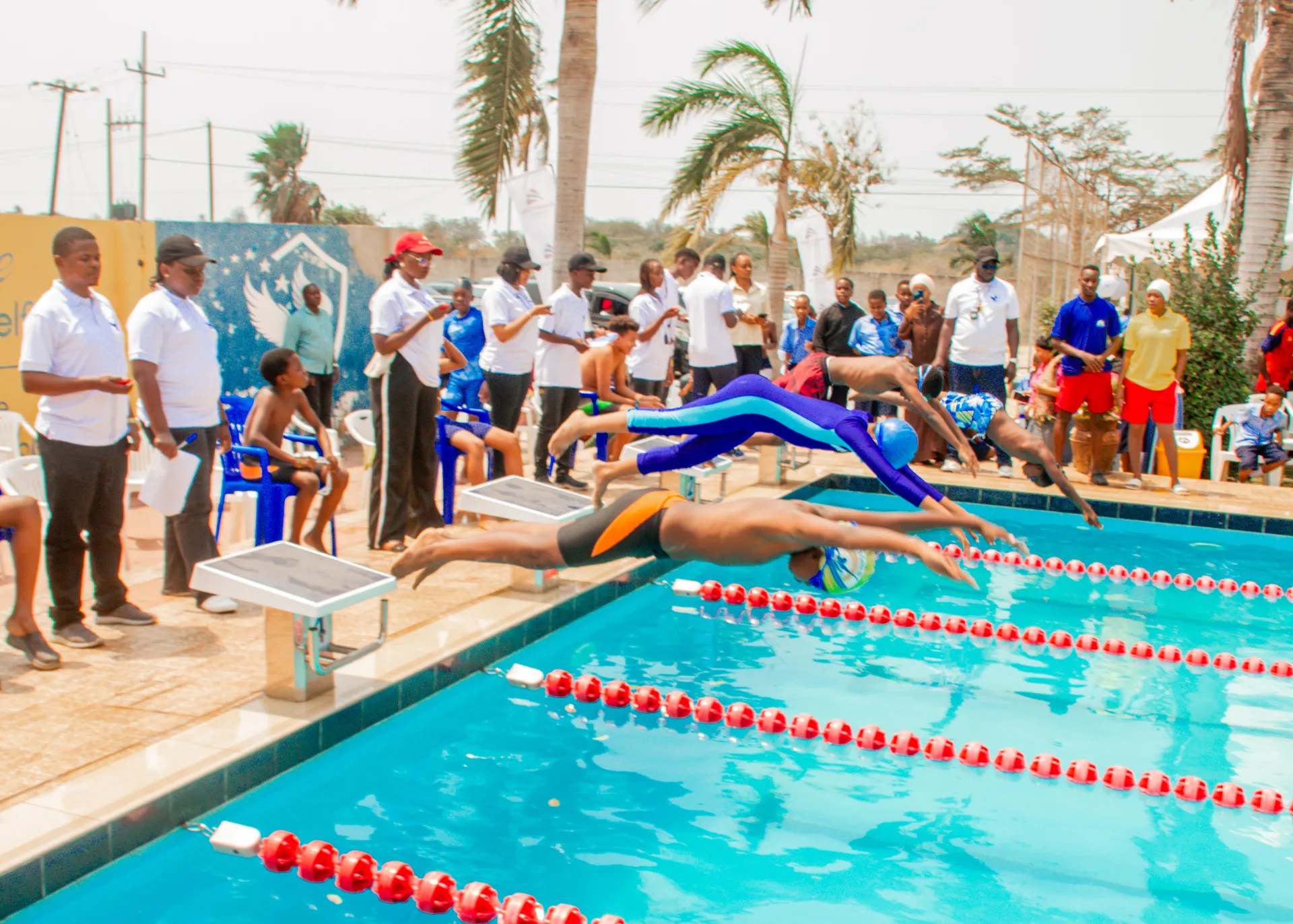 Milestones Academy swimmers launching into a race